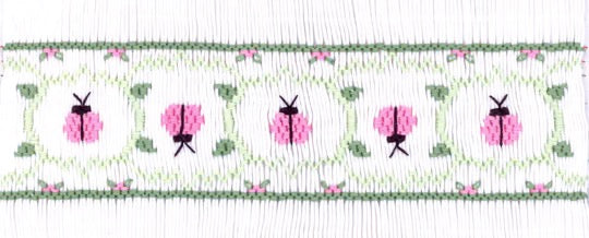 Smocking plate with five ladybugs facing up and down. 6 1/2 rows of smocking on a yoke.