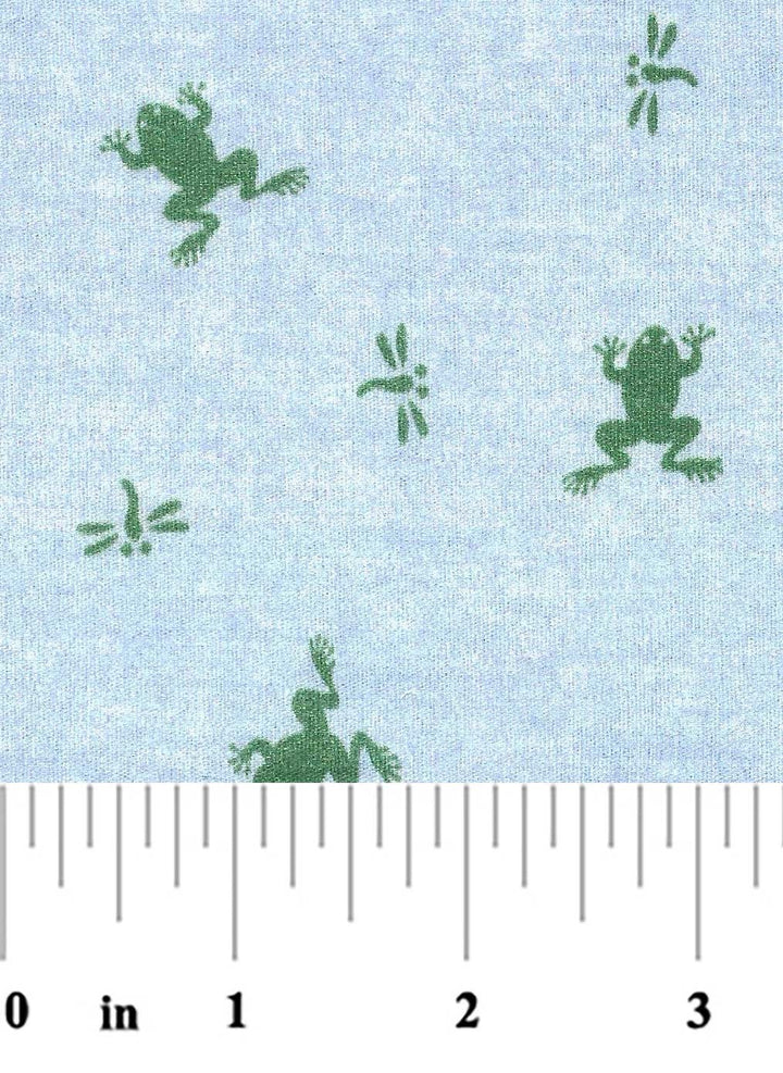 Fabric with green frog pattern on a light blue background, measured against a ruler.
