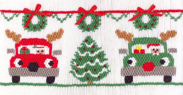 Smocking plate with reindeer cars, Santa, a tree and wreaths. 9 rows of smocking on a yoke.