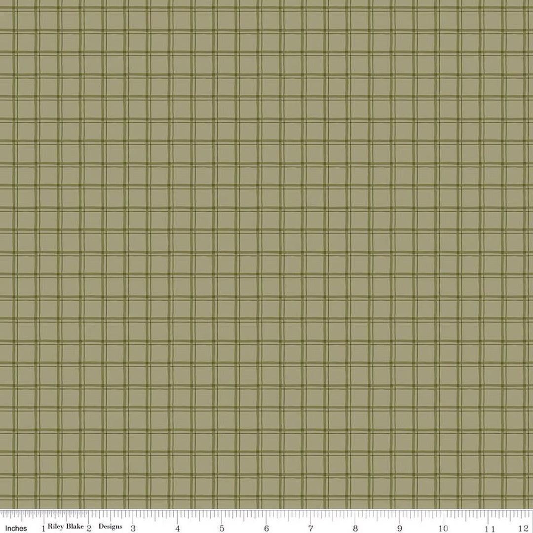 A close-up fabric pattern swatch showing a muted olive green and tan grid plaid design, with a 12-inch ruler scale along the bottom edge.