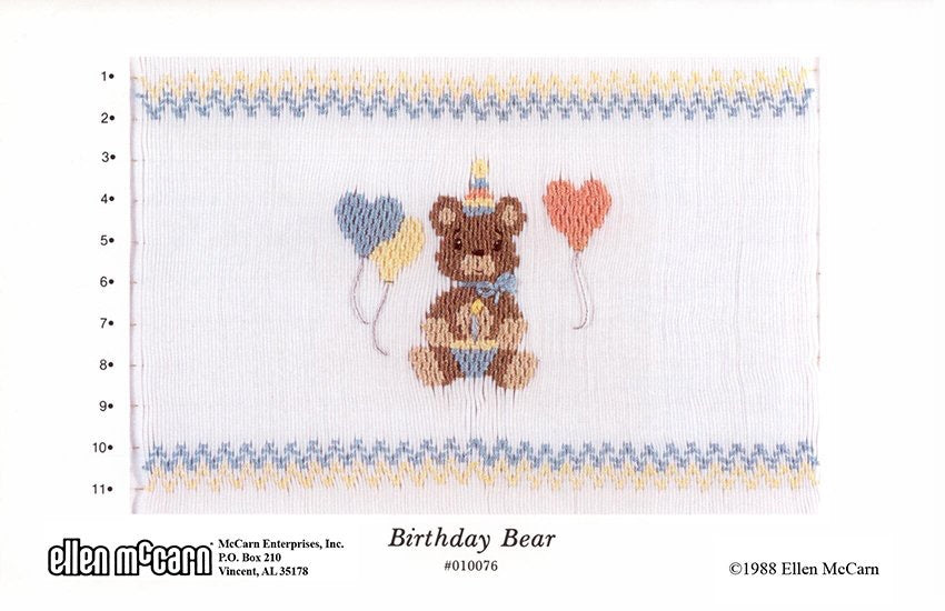 Smocking plate with a bear in a birthday hat with three heart balloons around the bear. 11 rows of smocking on a yoke.