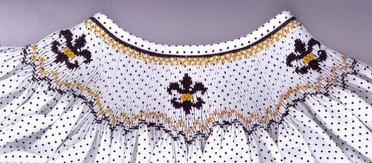 Smocking plate with fleur de lis. 7 rows of smocking on a bishop.