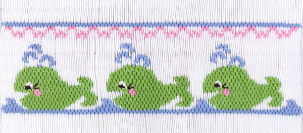 Smocking plate with three whales spouting water. 7 rows of smocking on a yoke.