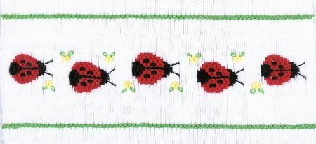 Smocking plate with five ladybugs. 8 rows of smocking on a yoke.