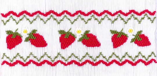 Smocking plate with strawberries. 8 rows of smocking on a yoke.