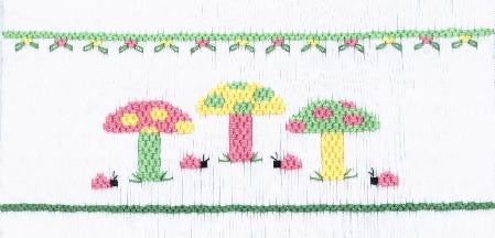 Smocking plate with three mushrooms. 8 rows of smocking on a yoke.