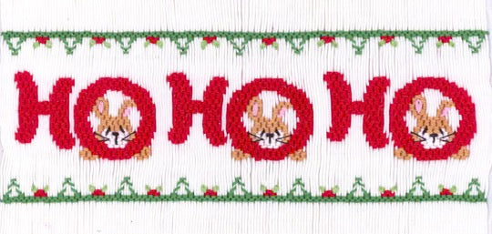 Smocking plate with "Ho Ho Ho" and bunnies. 8 rows of smocking on a yoke.