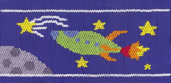 Smocking plate with a rocket ship, stars, the moon and a shooting star soaring through outer space. 8 1/2 rows of smocking on a yoke.