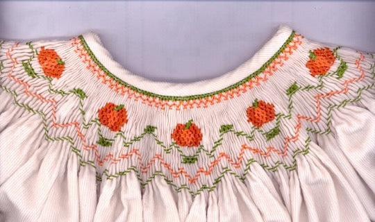 Smocking plate with pumpkins on a bishop. 7 rows of smocking on a bishop.