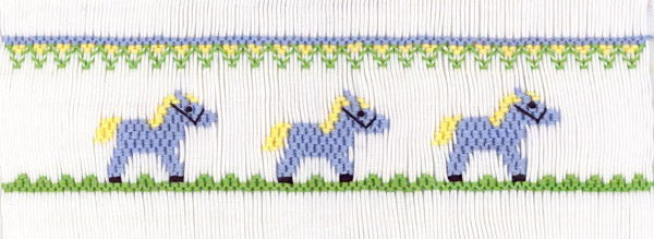 Smocking plate with three small ponies. 5 1/2 rows of smocking on a yoke.