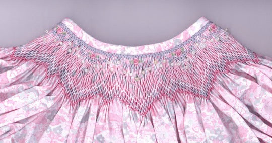 Smocking plate with geometric pattern with bullions and seed beads. 6 rows of smocking on a bishop.