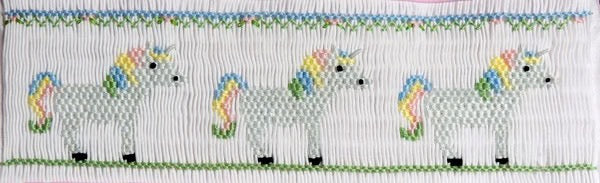 Magical unicorns with flowing colorful mane and tail. 7 rows or 160 pleats on a yoke.