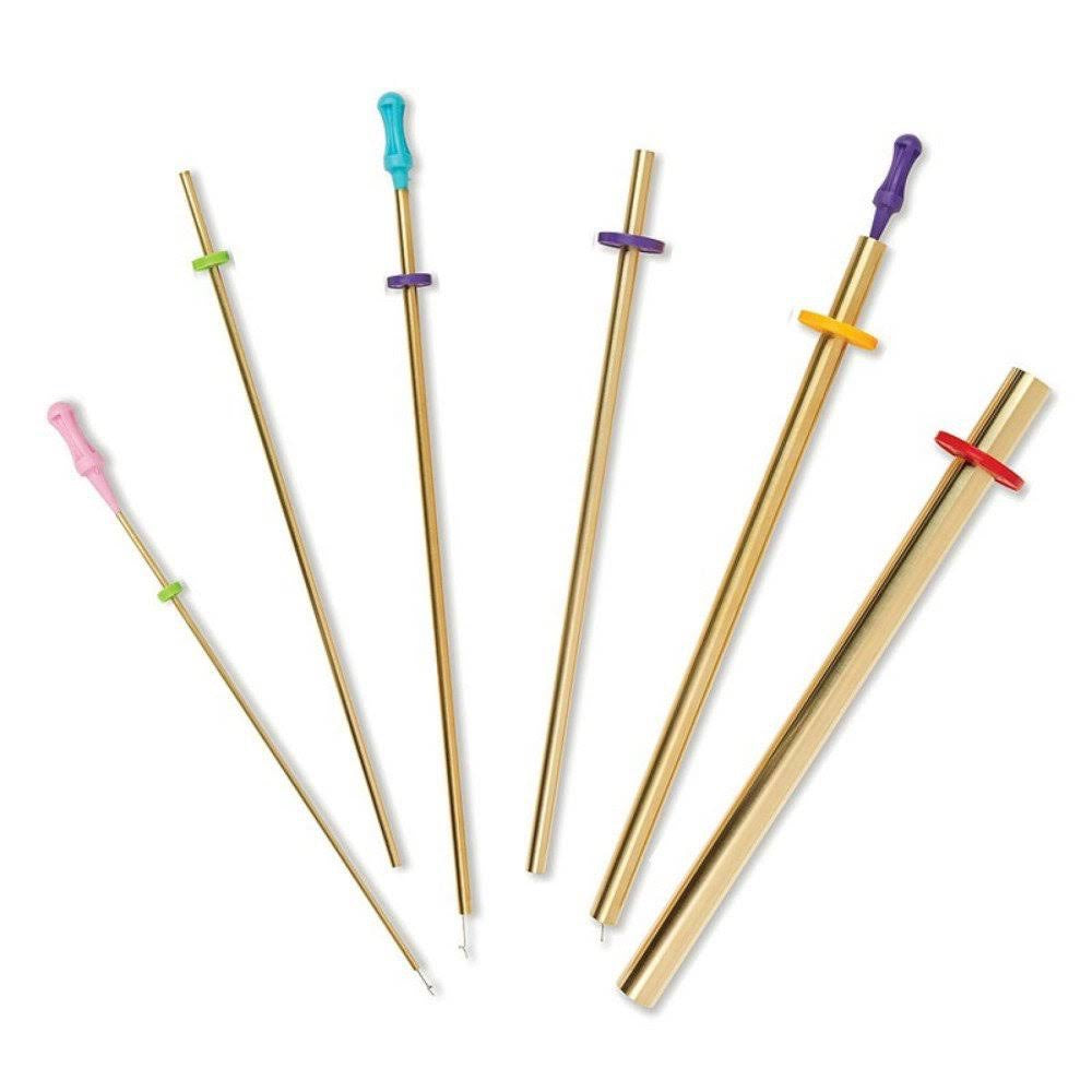 Set of gold fabric turners with colorful ends on a white background