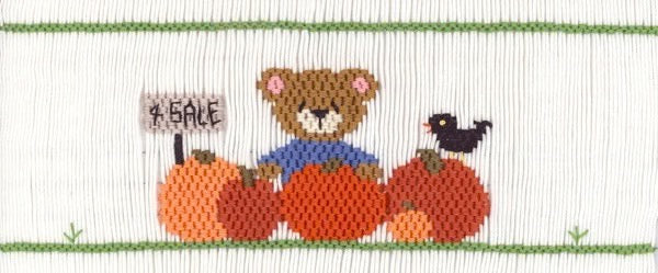 Smocking plate with a bear selling pumpkins from the patch . 8 rows of smocking on a yoke.