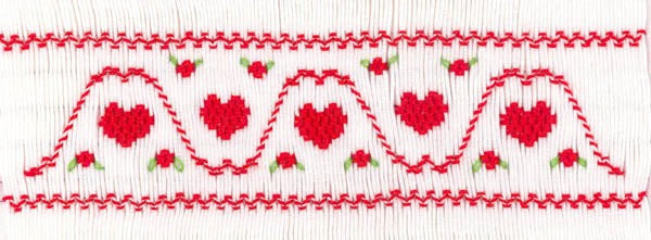 Smocking plate with heart design. 5 3/4 rows of smocking on a yoke.