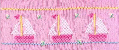 Smocking plate with three pink sailboats. 7 rows of smocking on a yoke.