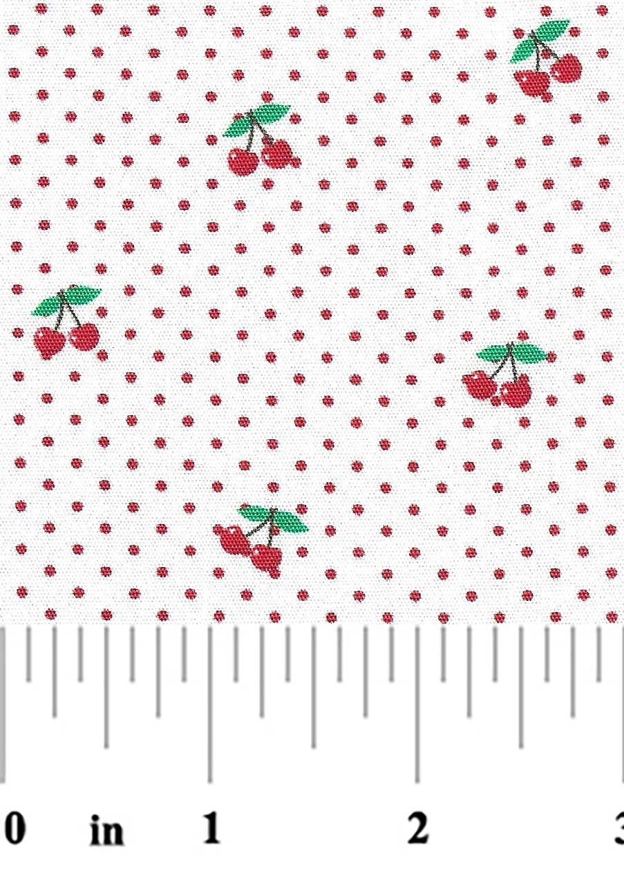 Fabric with cherry pattern and polka dots, measured by a ruler.