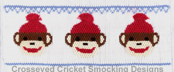 Smocking plate with smiling sock monkey faces. 8 rows on a yoke.
