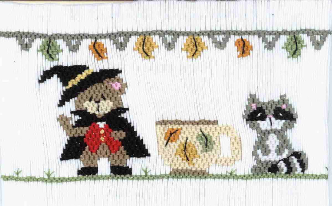 Smocking plate with a bear and a raccoon with a cup of tea. 9 rows of smocking on a yoke.
