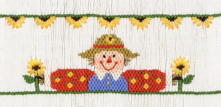 Smocking plate with a scarecrow and sunflowers. 8 rows of smocking on a yoke.