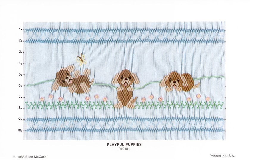 Smocking design of three puppies on a blue background with text 'Playful Puppies'.