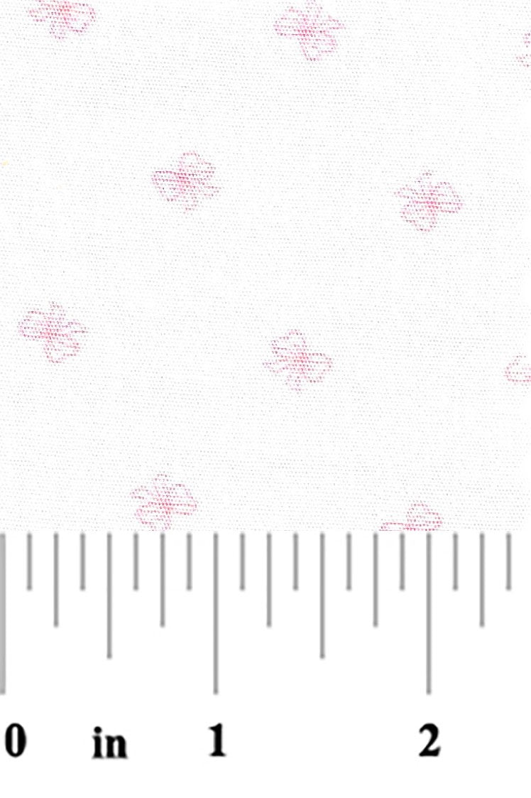 tiny pink bows on a white background with a ruler at the bottom for scale