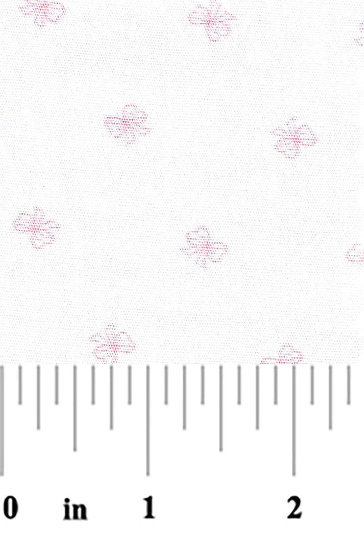 tiny pink bows on a white background with a ruler at the bottom for scale