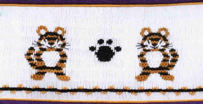 Smocking plate with two tigers and a paw print. 8 1/4 rows of smocking on a yoke.