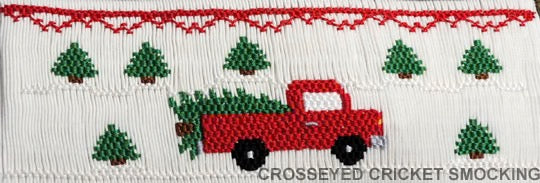 Red truck carrying Christmas trees on a white background with red trim.