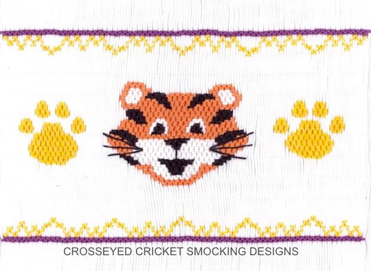 Smocked tiger design with paw prints and decorative elements on a white background.