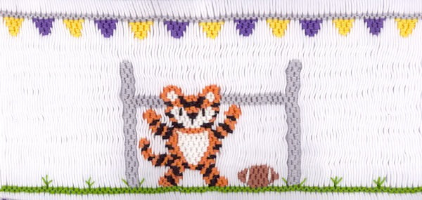 Smocking plate with a tiger playing football. 9 rows of smocking on a yoke.
