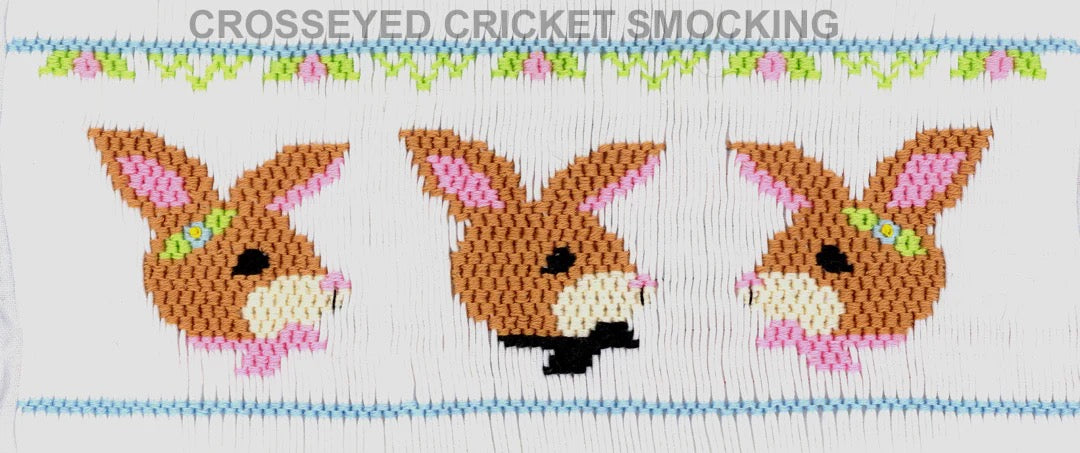 Smocking plate with a rabbits/hares in bow ties, ribbons and barrettes.  