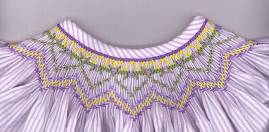 Geometric smocking plate with violets. 6 rows of smocking on a bishop.