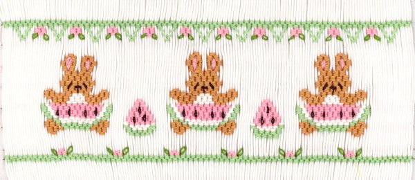 Smocking plate with three rabbits holding watermelon. 7 1/2 rows of smocking on a yoke.