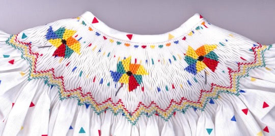 Smocking plate with pinwheels. 8 3/4 rows of smocking on a bishop.