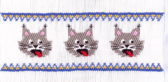 Smocking plate with wild cats. 8 rows of smocking on a yoke.