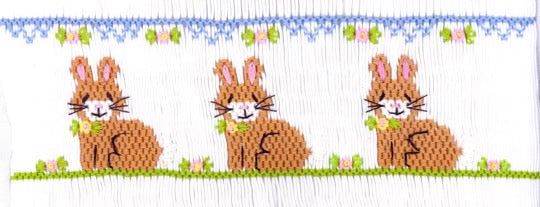 Smocking plate with three bunnies/rabbits in a row. 7 rows of smocking on a bishop.