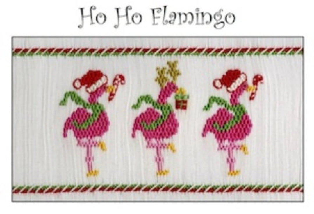 A cross-stitch pattern design titled 'Ho Ho Flamingo' featuring three pink flamingos wearing red Santa hats and green scarves, decorated with candy canes and a small Christmas tree, on a white stitched canvas with red and green striped borders.