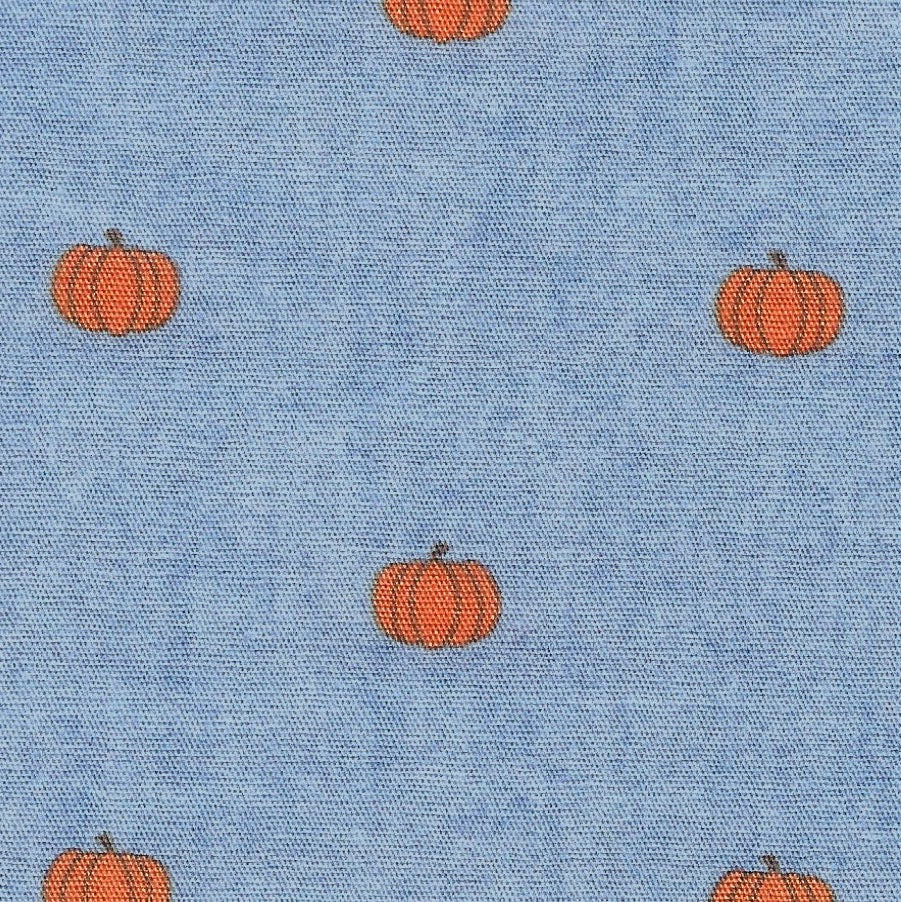 Pattern of orange pumpkins on a blue fabric background