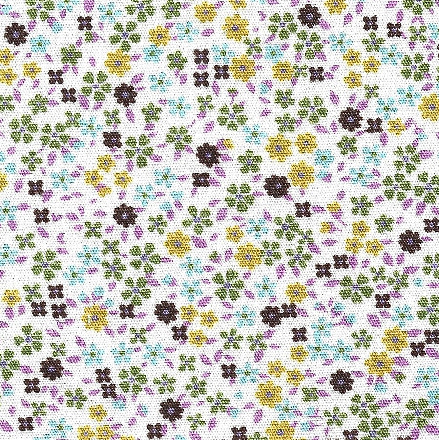 Small floral pattern with green, yellow, and purple flowers on a white background