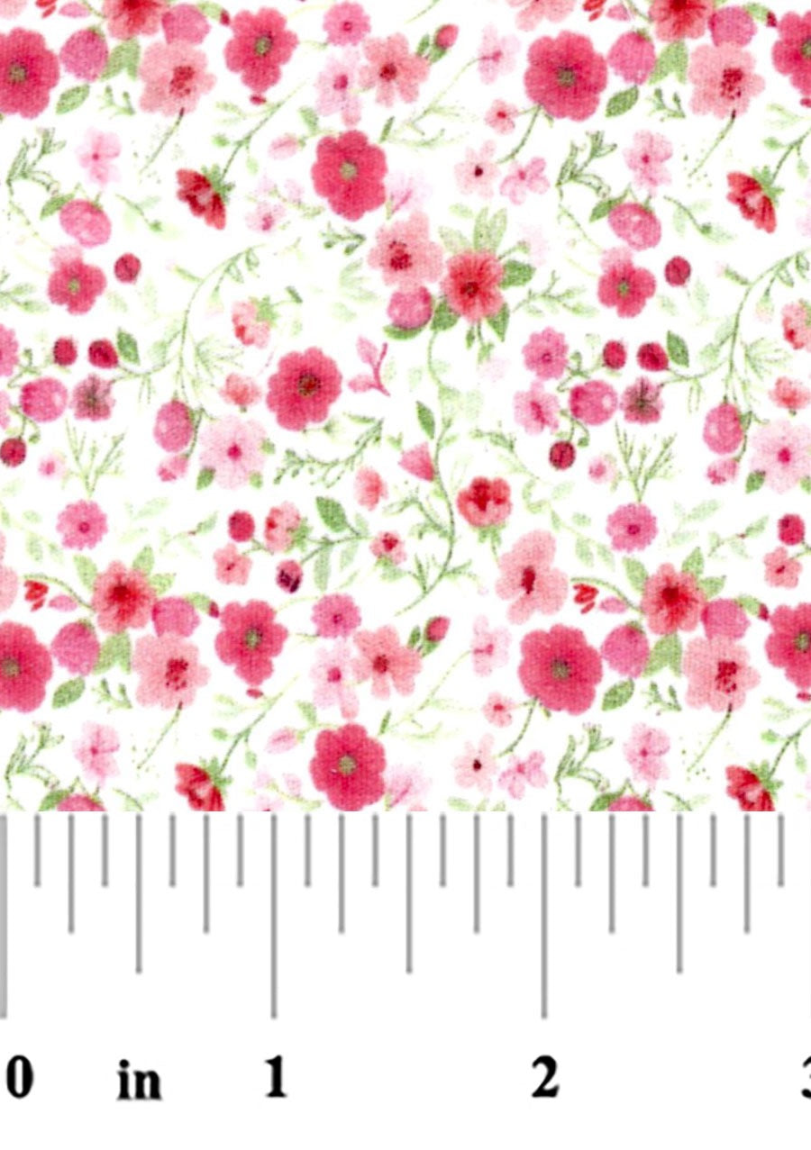 pink and green floral fabric swatch with a ruler at the bottom for scale