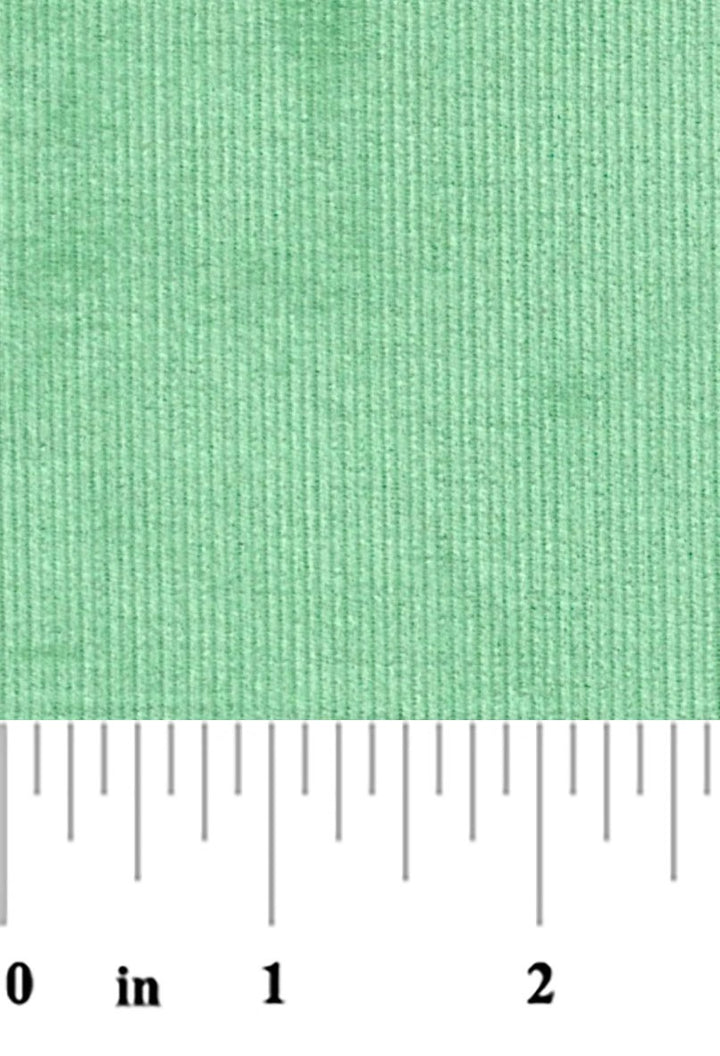 fabric swatch of chive color 21 wale corduroy fabric with a ruler at the bottom for scale