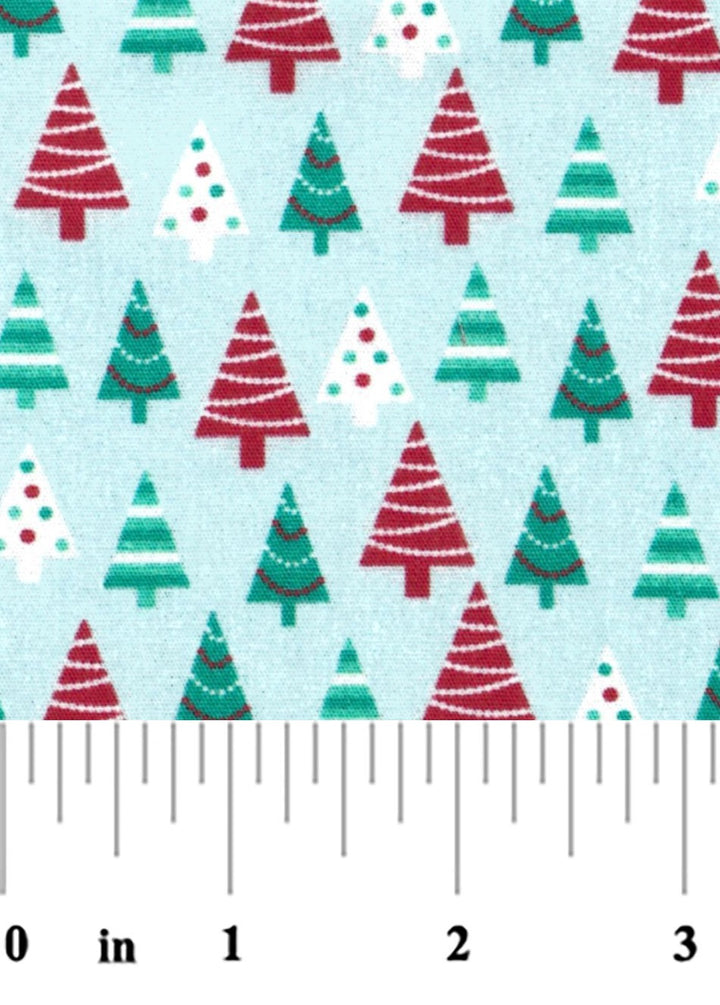 fabric swatch of red and green Christmas Trees on a light blue background with a ruler at the bottom for scale.