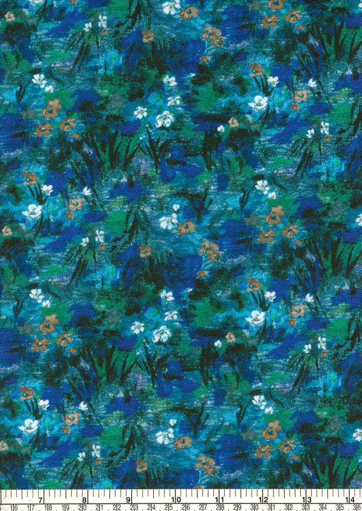 Fabric with a floral pattern in blue, green, and white on a ruler for scale.