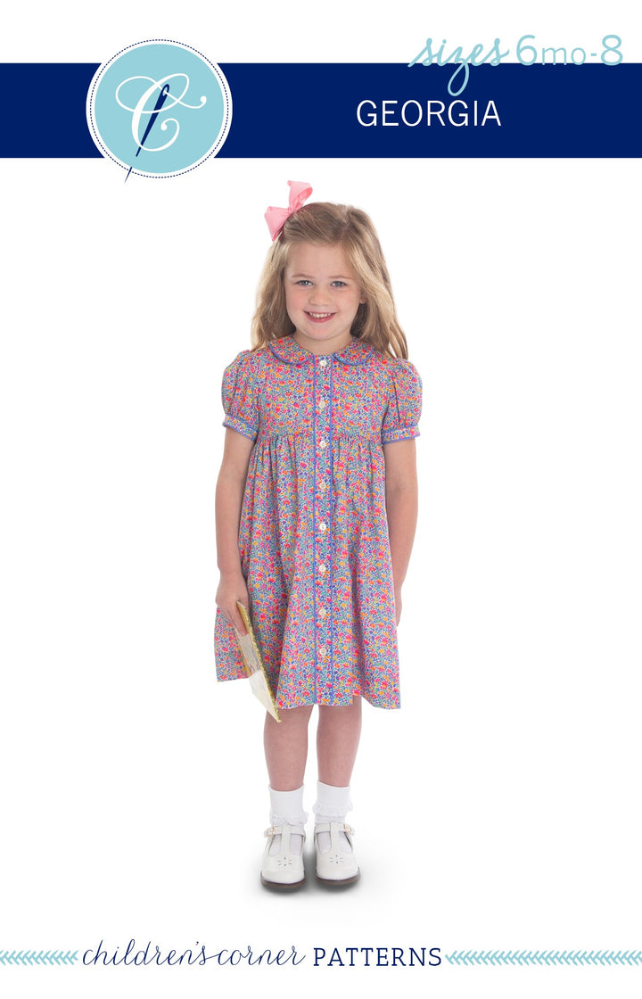 A young girl modeling a short-sleeve button-front dress with a colorful floral print, shown against a white background with a blue header that reads 'ages 6mo-8 GEORGIA' and 'children's corner PATTERNS'.
