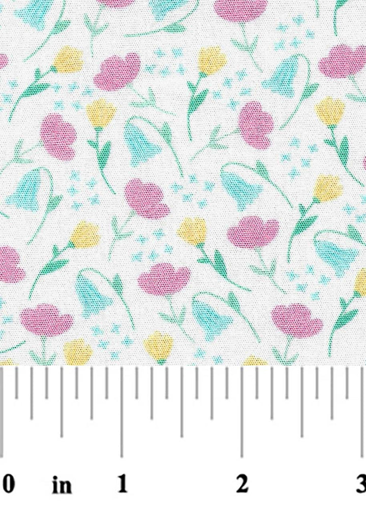 Floral pattern with pink, yellow, and blue flowers on a white background, measured against a ruler.