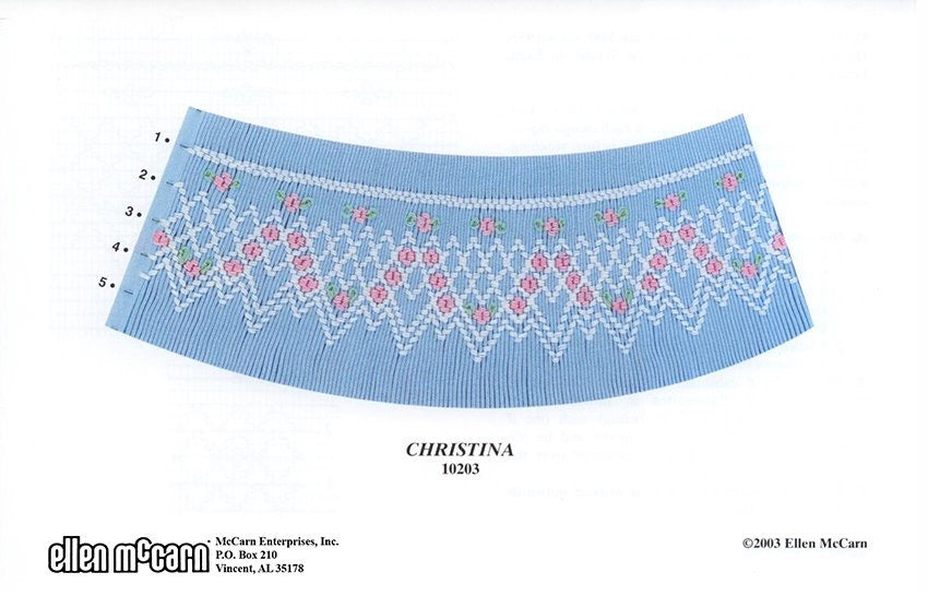 5 row geometric smocking design smocked in white, pink, and green on blue pleated fabric
