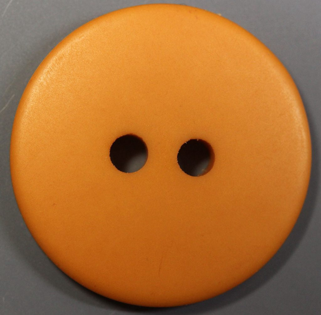 Orange button with two holes on a gray background