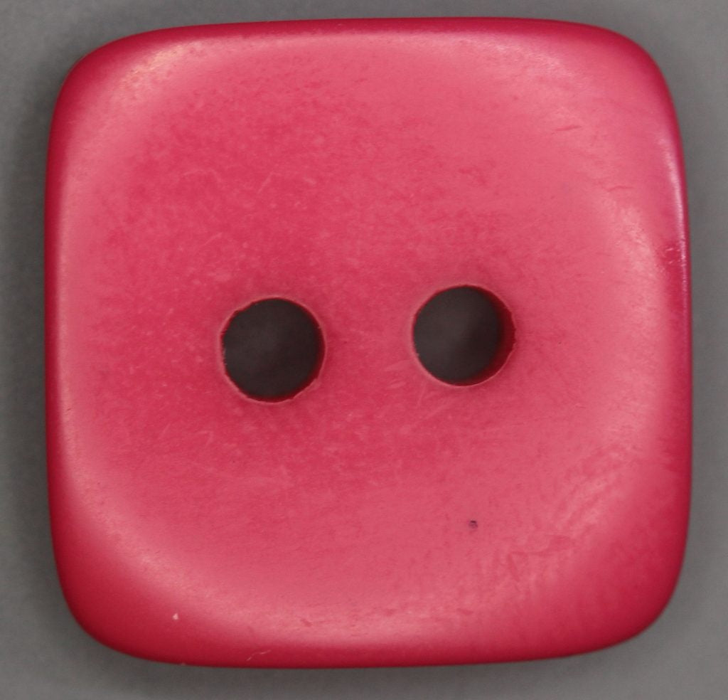 Dark pink square button with two holes on a gray background