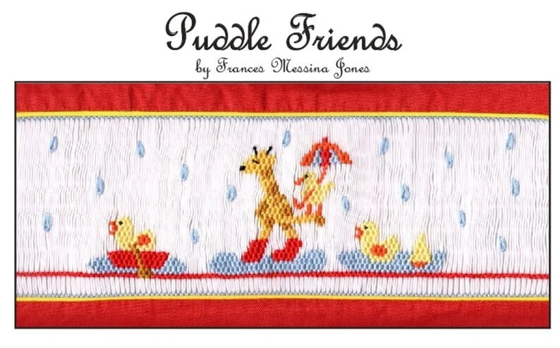 A smocking plate titled 'Puddle Friends' by Frances Messina Jones, featuring a white stitched background with raindrops, a giraffe in red boots, a duck with an umbrella, and yellow duck a in red boat.